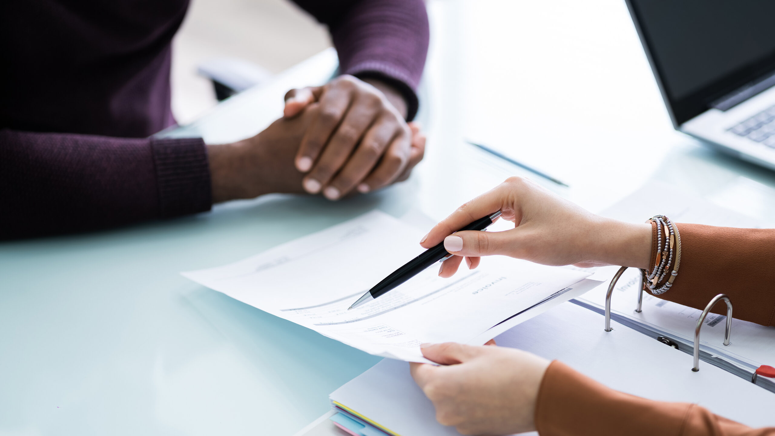 Financial Advisor Discussing Invoice With Her Client